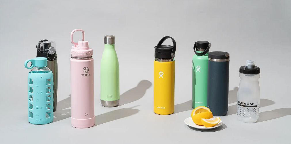 Various water bottles for hydration displayed in a row, showcasing different colors, shapes, and materials.