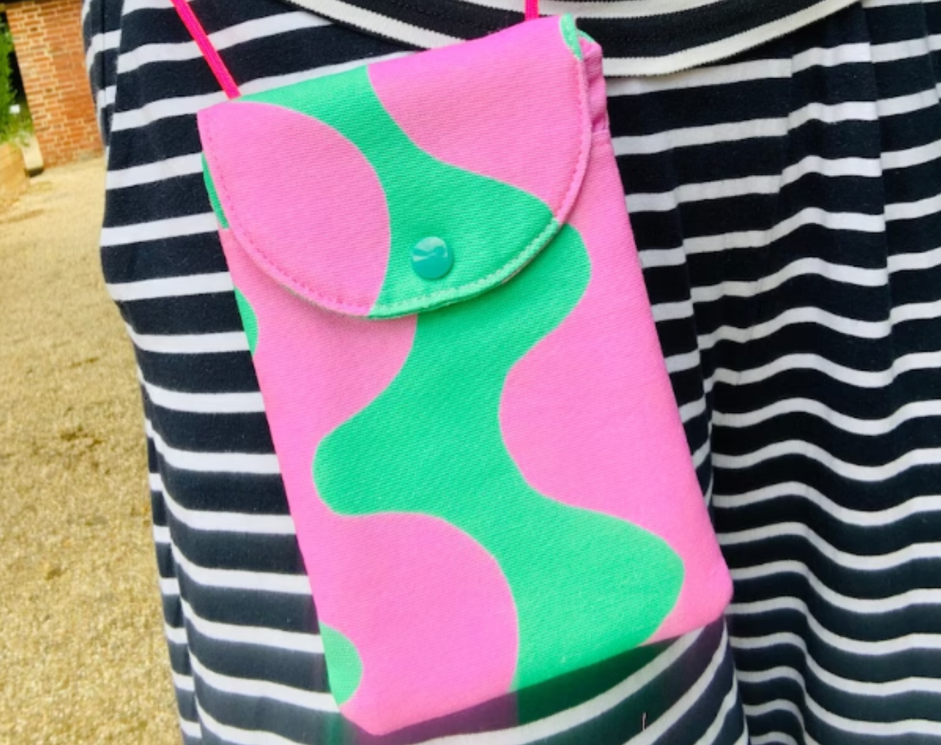 Stylish gift for teens: Crossbody phone purse with vibrant colors and playful pattern.