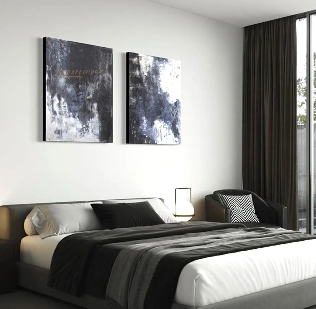 Dark bedroom with standout pieces of art and bed