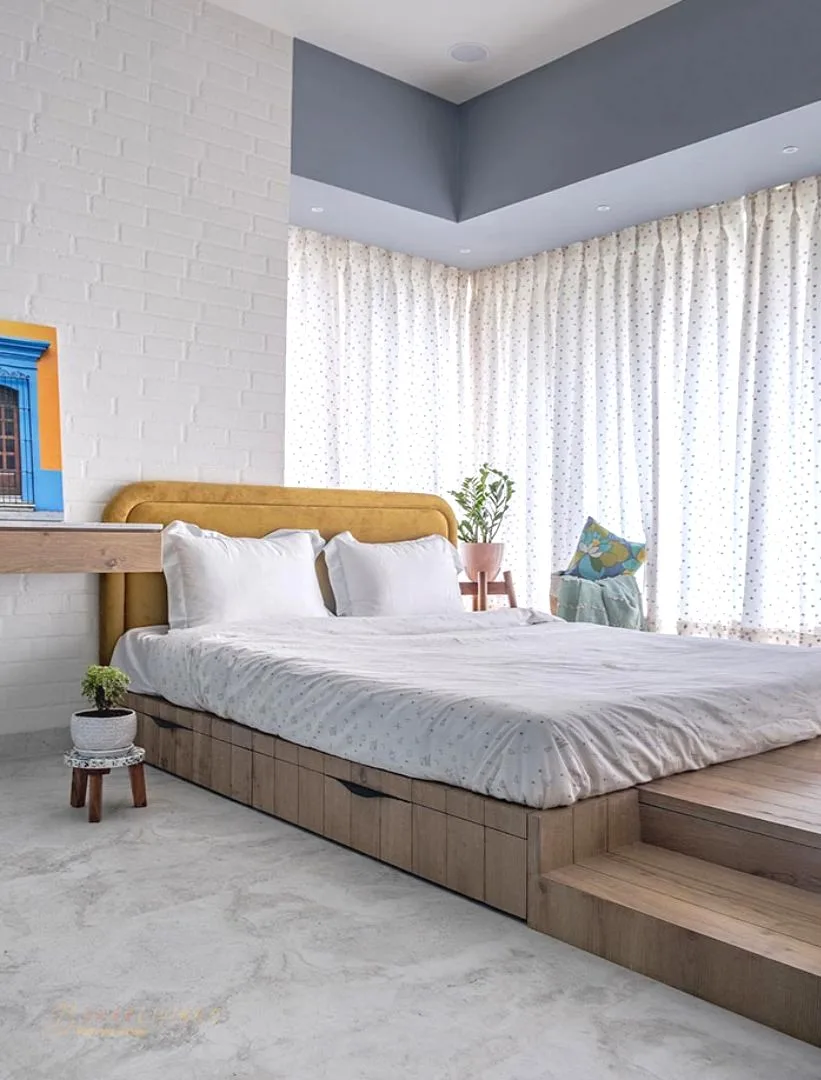 Bed platform in a white bedroom