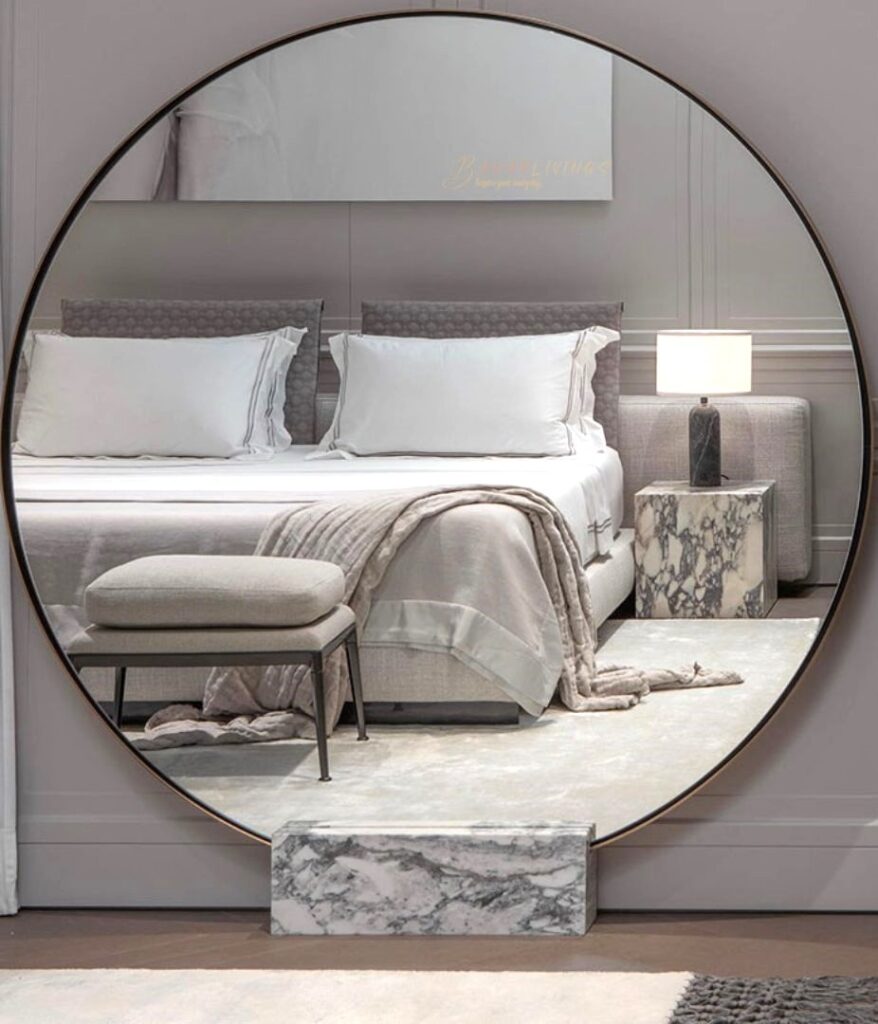 Big Round mirror in a cozy spacious bedroom 
